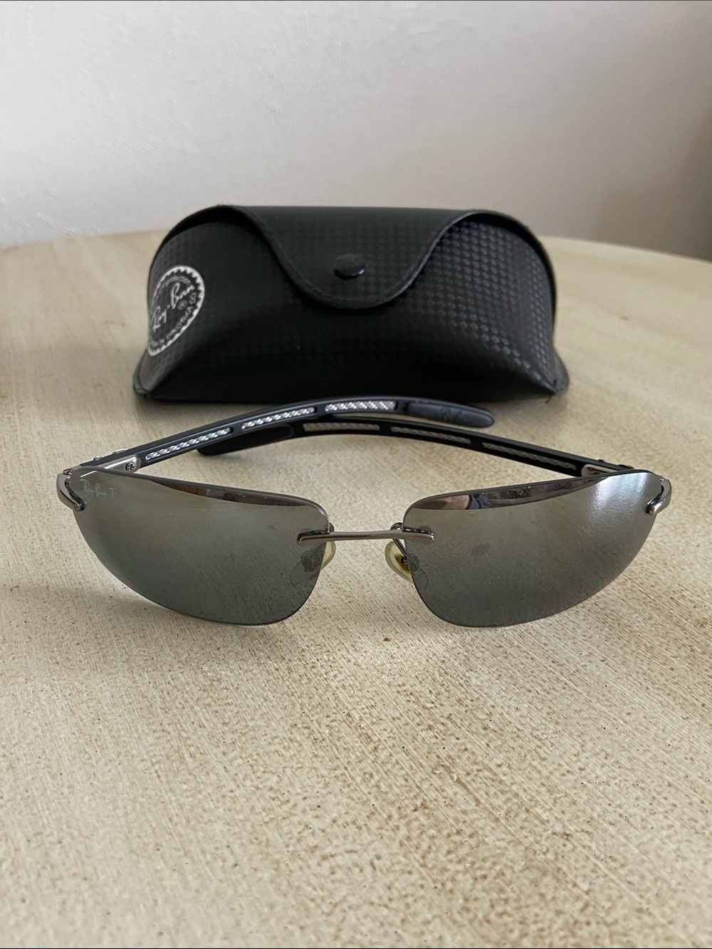 Ray-Ban RB8303 sunglasses featuring a rimless rectangular design and lightweight
